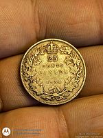 Reverse showing 25 CENTS CANADA 1934 with maple leaf wreath and crown