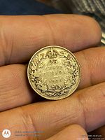 Reverse maple leaf wreath side with 25 CENTS CANADA 1936