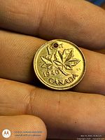 Reverse showing maple leaves, 1946 date visible, hole near rim