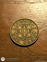 Obverse of 1940 Jamaica One Penny showing coat of arms, date, denomination