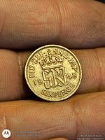 Reverse of 1948 sixpence coin showing crowned cypher and date