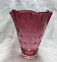 Full view of cranberry glass vase showing ruffled rim and thumbprint pattern