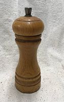 Full view of oak pepper grinder front profile