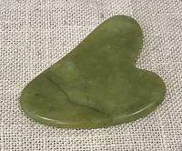 Front view of green jade slab on fabric background