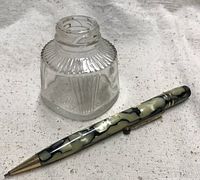 Pencil and inkwell together showing size and style