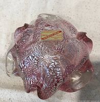 Top view showing ruffled shape, pink color, silver flecks, original label