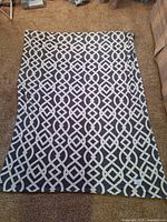 Full view of gray and white geometric fleece throw spread out