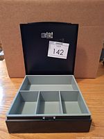 Open cash box showing interior tray