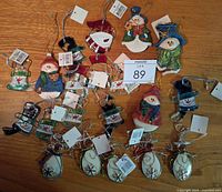 Group of assorted glass snowman and wire reindeer ornaments displayed on wood surface