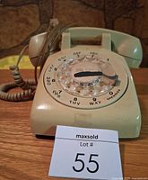 Front view showing rotary dial, handset, cords