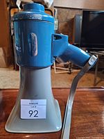 Full view of blue and gray Fanon megaphone with handle and bracket