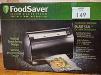 Box front showing FoodSaver vacuum sealing system branding and image of appliance