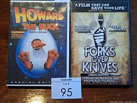 Front covers of both DVD cases displayed on a wooden surface