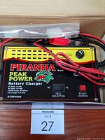 Charger inside open box with leads visible