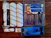 All contents laid out: packaged roller sleeve, two loose roller sleeves, mini roller sleeve, brush set, sanding block