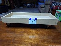 Side view of rectangular wood cart on casters