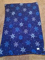 Full view of blue fleece blanket showing pattern and size
