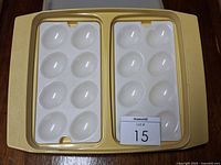 Keeper open showing two 6-egg trays inside yellow base