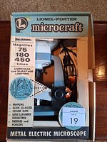 Boxed Lionel-Porter Microcraft metal electric microscope with accessories visible
