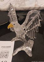Front view of Swarovski crystal eagle on branch