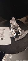 Front view of Swarovski crystal Cinderella figurine on frosted stair base