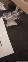 Front view of Swarovski crystal hummingbird on two flowers