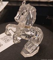 Front three-quarter view of faceted crystal horse on base
