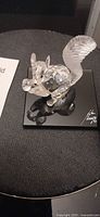 Crystal squirrel figurine on mirrored base showing engraved signature