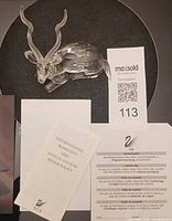 Top view of crystal kudu figurine with paperwork visible