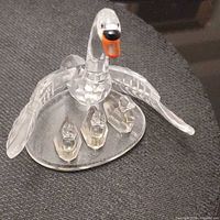 Front view of faceted crystal mother swan with three cygnets on base