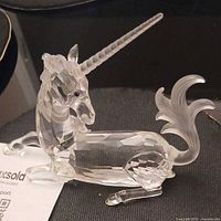 Left side view of Swarovski crystal unicorn showing faceted body and frosted accents