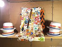 Overall view of two foam boater hats and central pinback button banner