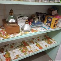 Shelf with assorted reflector bulbs, boxed LED bulbs, cardboard-sleeved flood lamps