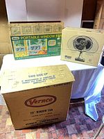 Three boxed vintage fans: Vernco, Marvin window fan, Galaxy oscillating fan