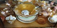 Group shot showing carnival glass bowls, plate stack, milk glass basket