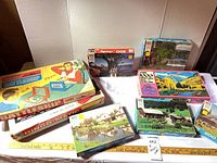 Full lot with board games and five puzzle boxes displayed