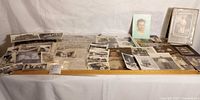 Overview of entire lot laid out with ruler showing variety of photos, cabinet cards, album and certificates