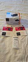 Sony Handycam HDR-CX240 retail box, two sealed 16GB Sony microSDHC cards, lot tag visible