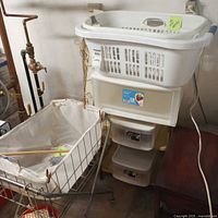 Overall view of rolling metal laundry cart with canvas liner