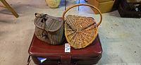 All three items: suitcase base, fishing creel, picnic basket visible