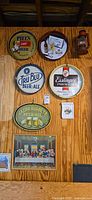 Full view of six beer trays/signs and framed print on wall