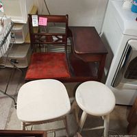 Full view of telephone bench and two white stools