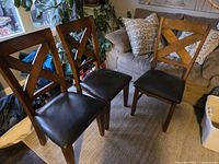 Three of the four X-back chairs showing overall design and condition