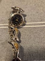 Full watch view showing dial and dolphin link bracelet