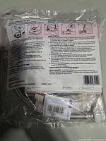 Rear of sealed Oatey Toilet Contractor Kit showing contents list and braided supply line visible inside.