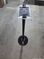 Full view of freestanding tablet stand showing pole, base and mount