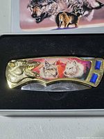 Knife in case showing wolf artwork handle