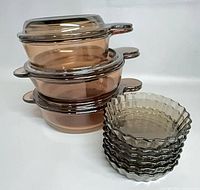Stacked three Corning Visions bowls beside six Arcopal tartlet dishes