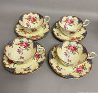 Set of four Aynsley teacups on saucers, full view