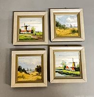All four framed Dutch paintings laid out together